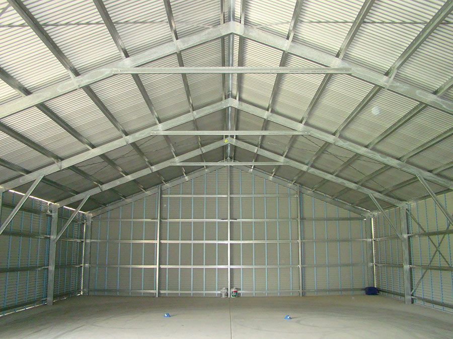 The Inside of a Large Warehouse With a Metal Roof — Just Sheds In Kunda Park, QLD