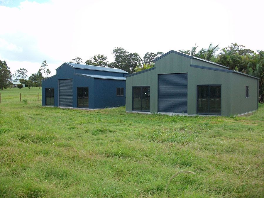 Two Sheds Are Sitting in the Middle of a Grassy Field — Just Sheds In Kunda Park, QLD