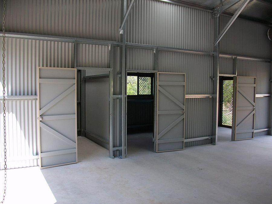 A Building With a Lot of Doors That Are Open — Just Sheds In Kunda Park, QLD