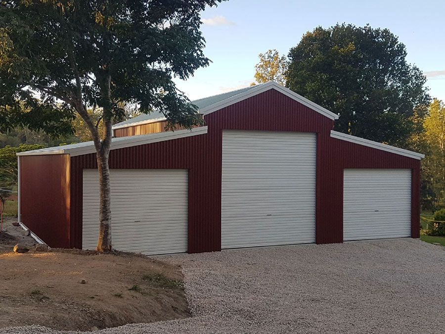 A Red and White Garage With a Tree in Front of It  — Just Sheds In Kunda Park, QLD