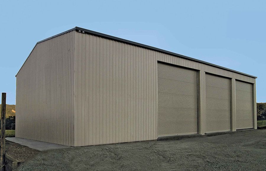 A Large Metal Building With Three Garage Doors — Just Sheds In Kunda Park, QLD