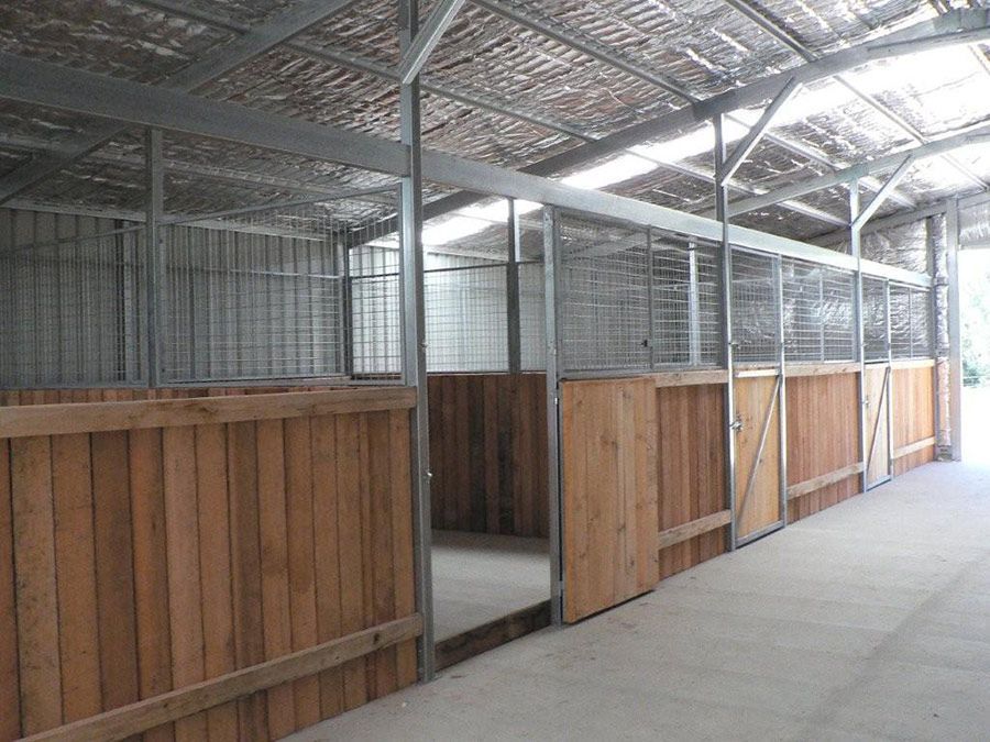 A Row of Horse Stables With Wooden Walls and Metal Fences — Just Sheds In Kunda Park, QLD