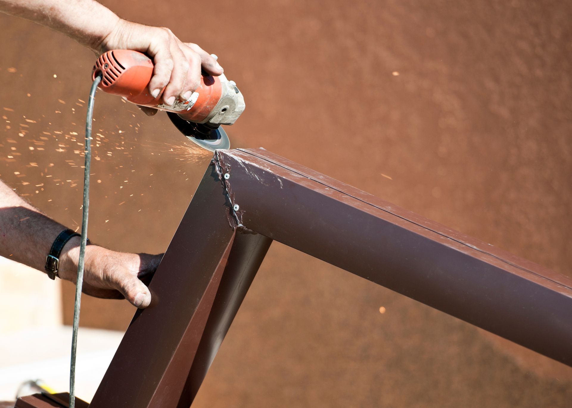 A worker is repairing a gutter.