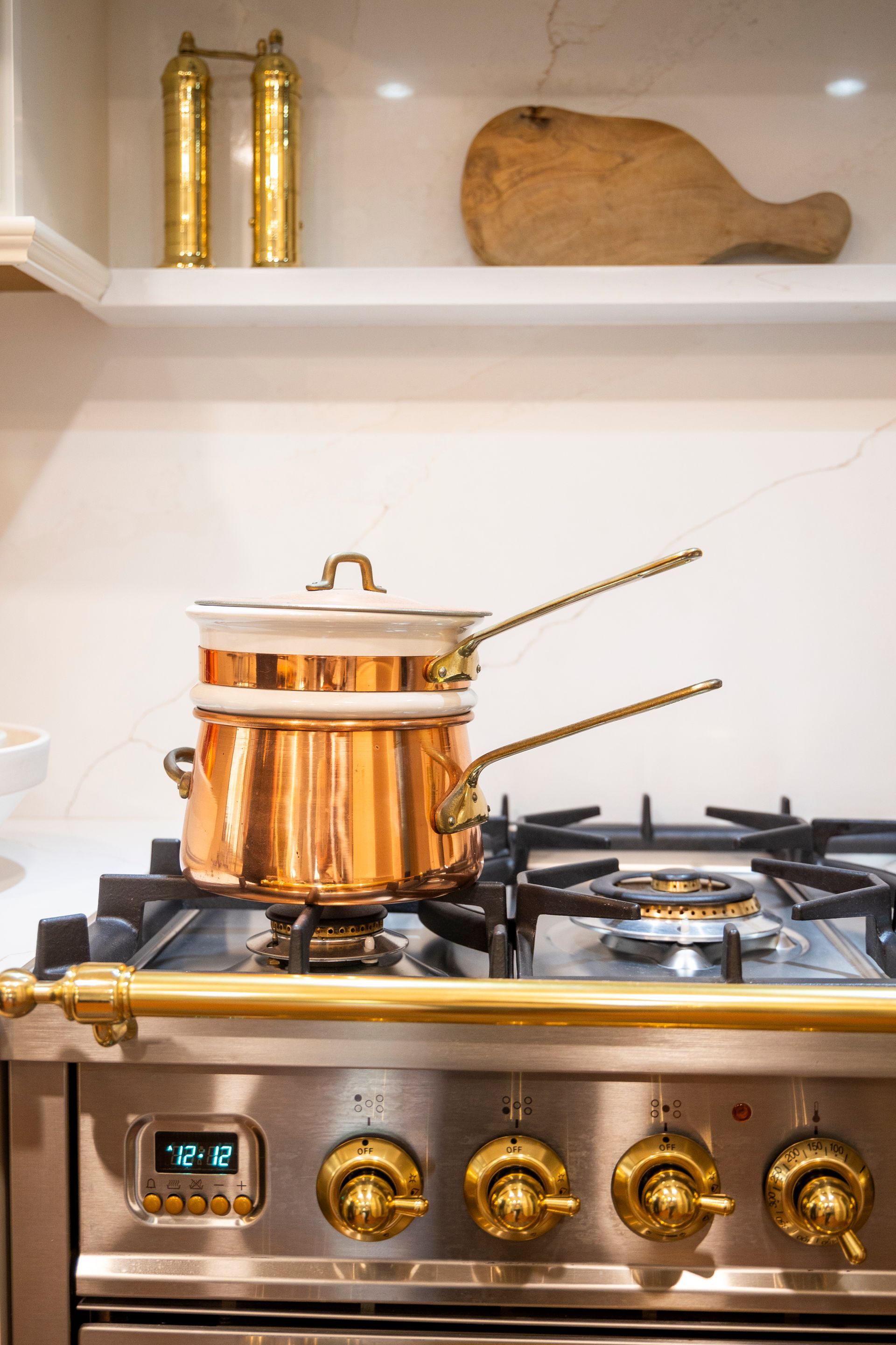 A pot is cooking on a stove in a kitchen.