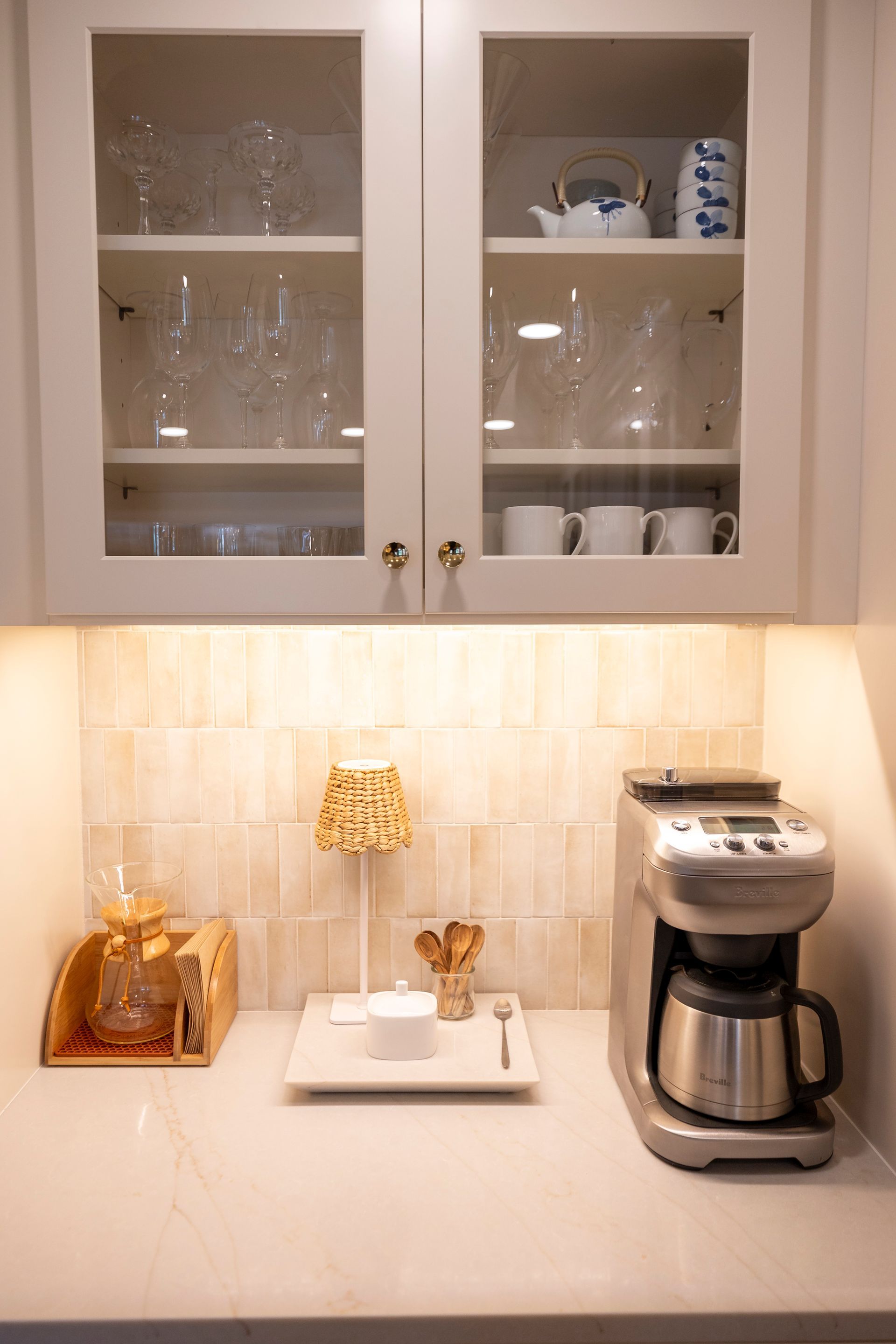 A coffee maker is sitting on a counter in a kitchen.