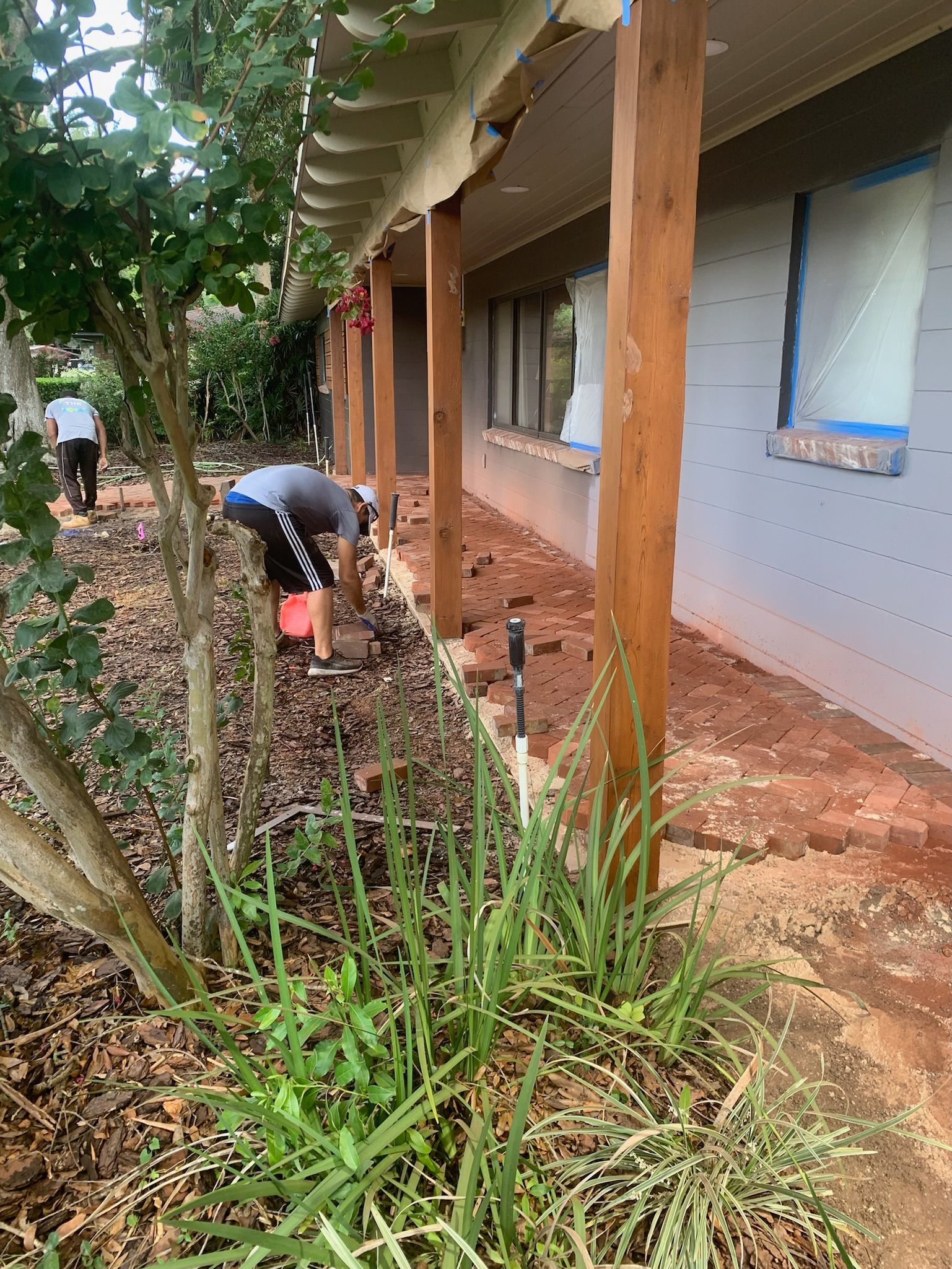 Florida home remodeling project with workers updating front patio.