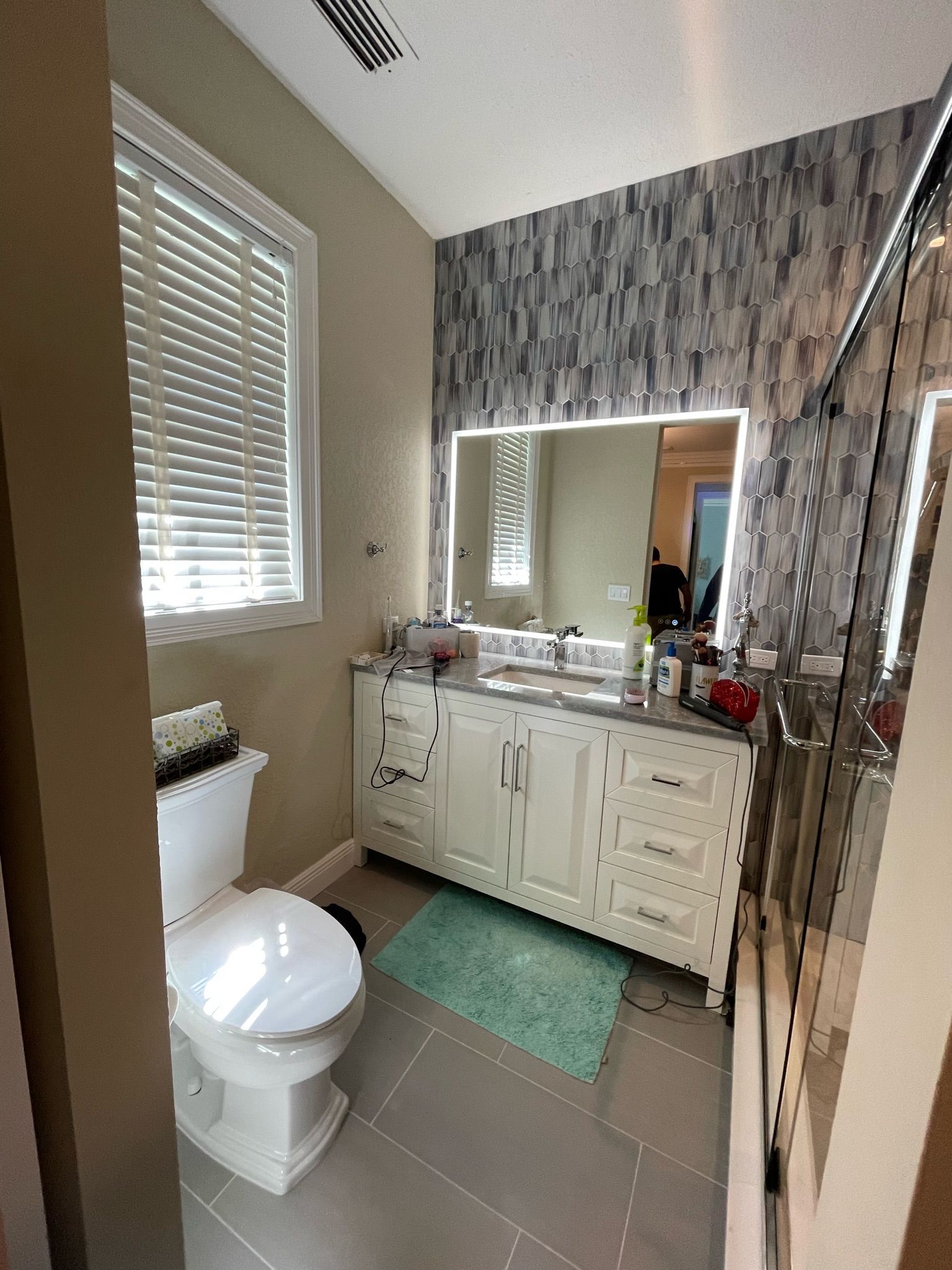 Energy-efficient bathroom: Natural light, low-flow toilet, and sustainable tiles