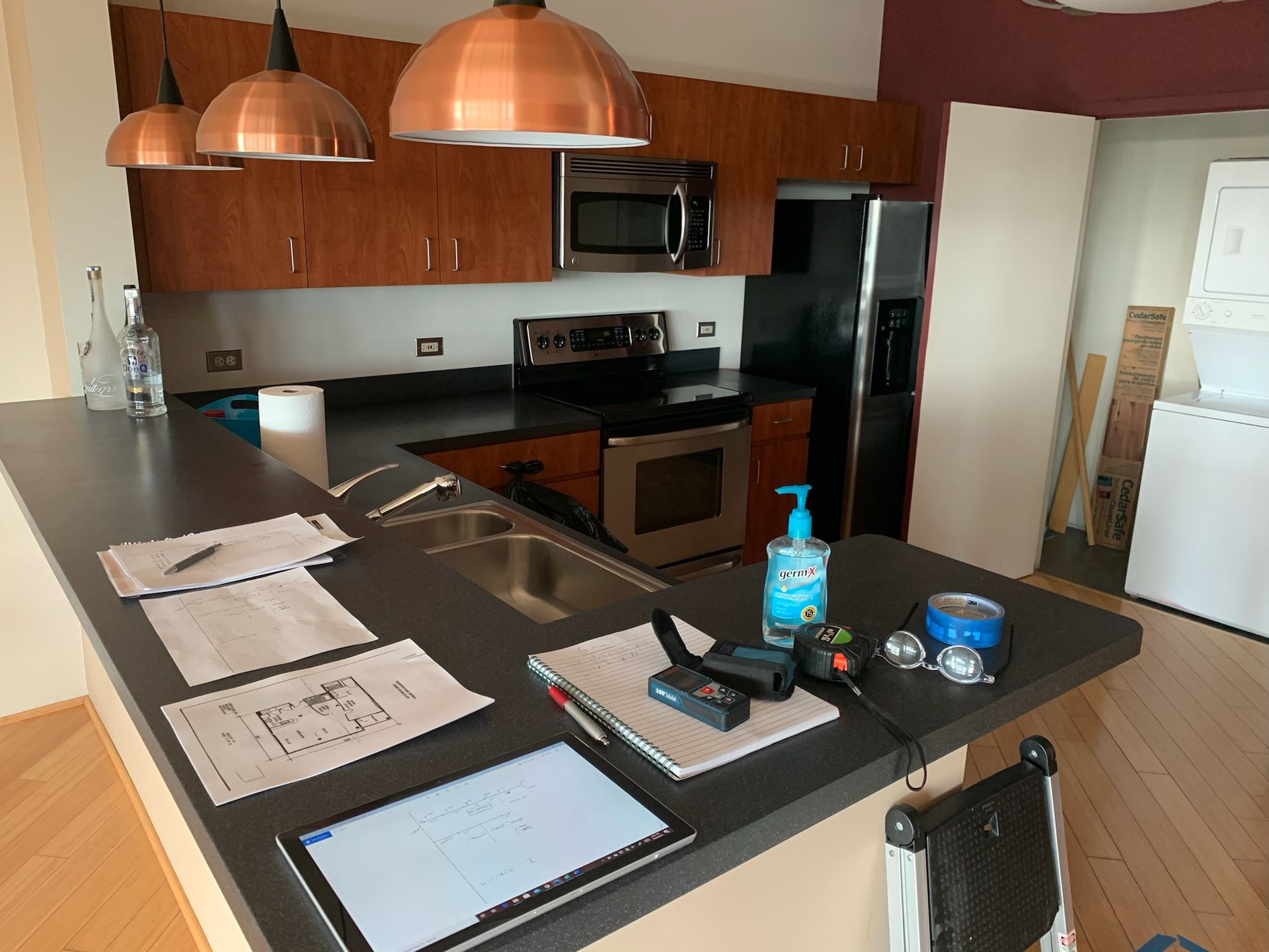 Orlando kitchen remodel: Blueprints and tools on granite island, prepping adjustable shelves.