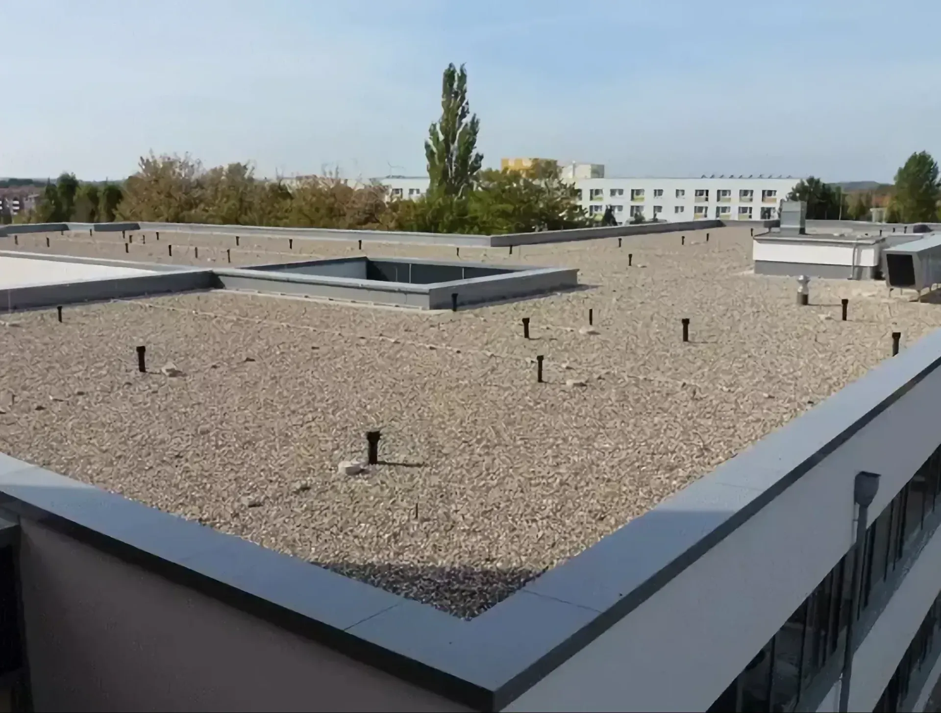 Gravel-covered flat roof of a building.
