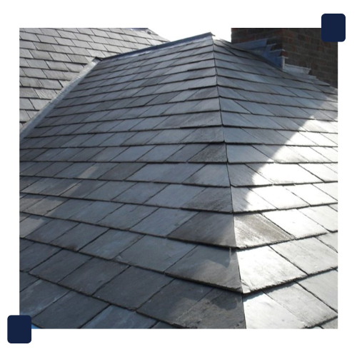 Slate roof with dark gray tiles, showing a hipped roof section.