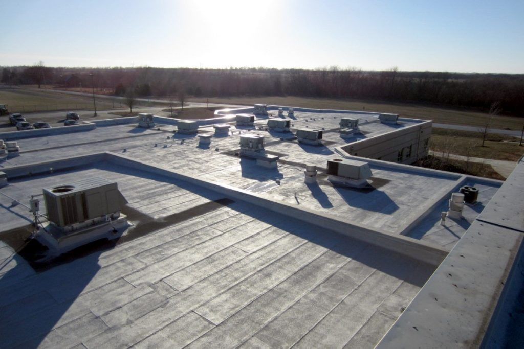 A flat commercial rooftop with multiple HVAC units