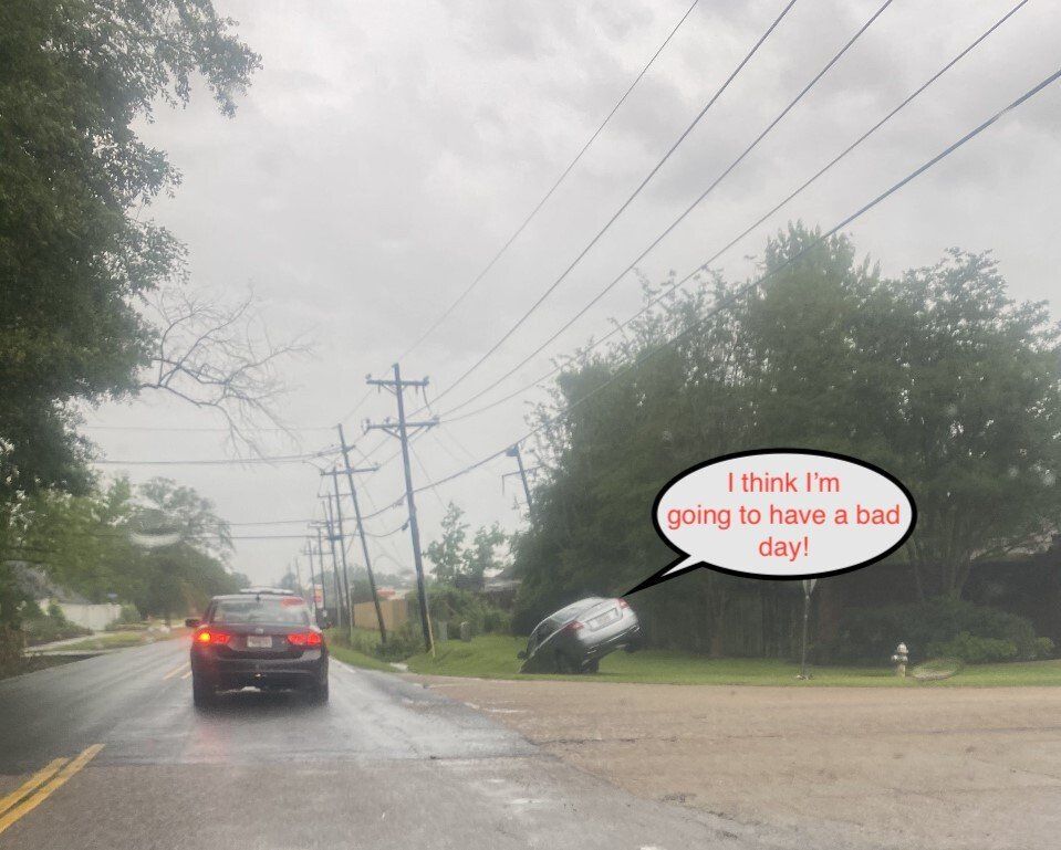 Car flipped on side near power lines and roadway in cloudy weather; person is in distress.