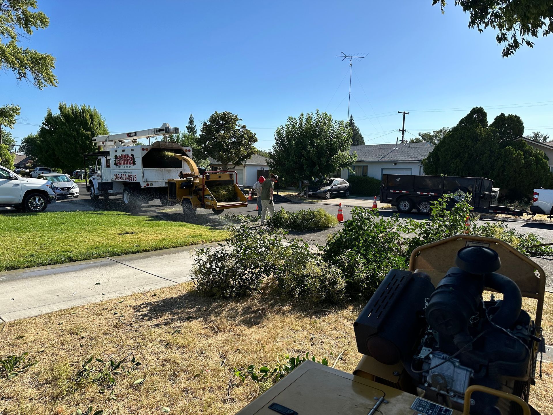A tree stump grinder is parked on the side of the road