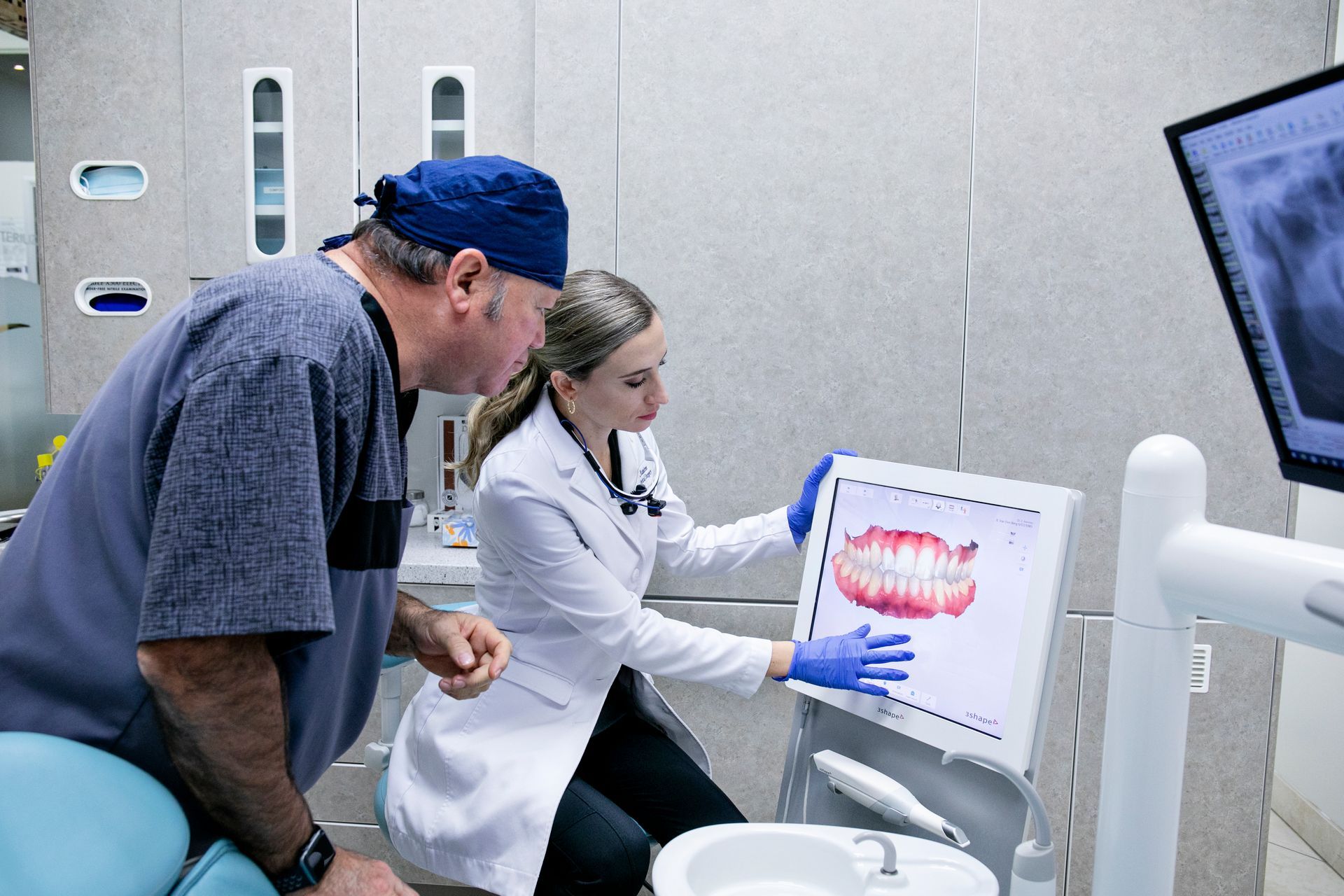 A woman is getting a laser treatment on her face in a dental office.