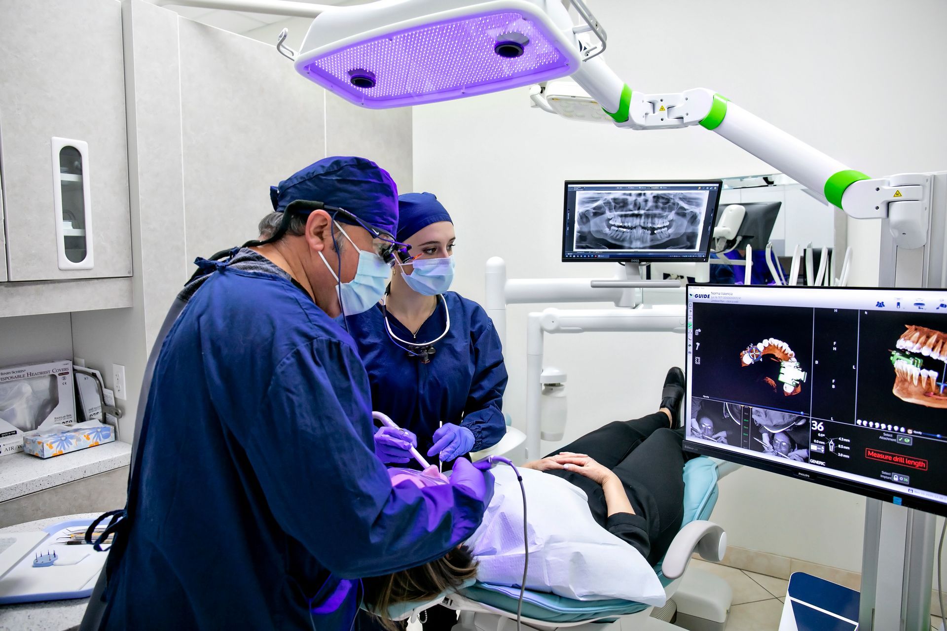 A dentist is working on a patient in a dental office.