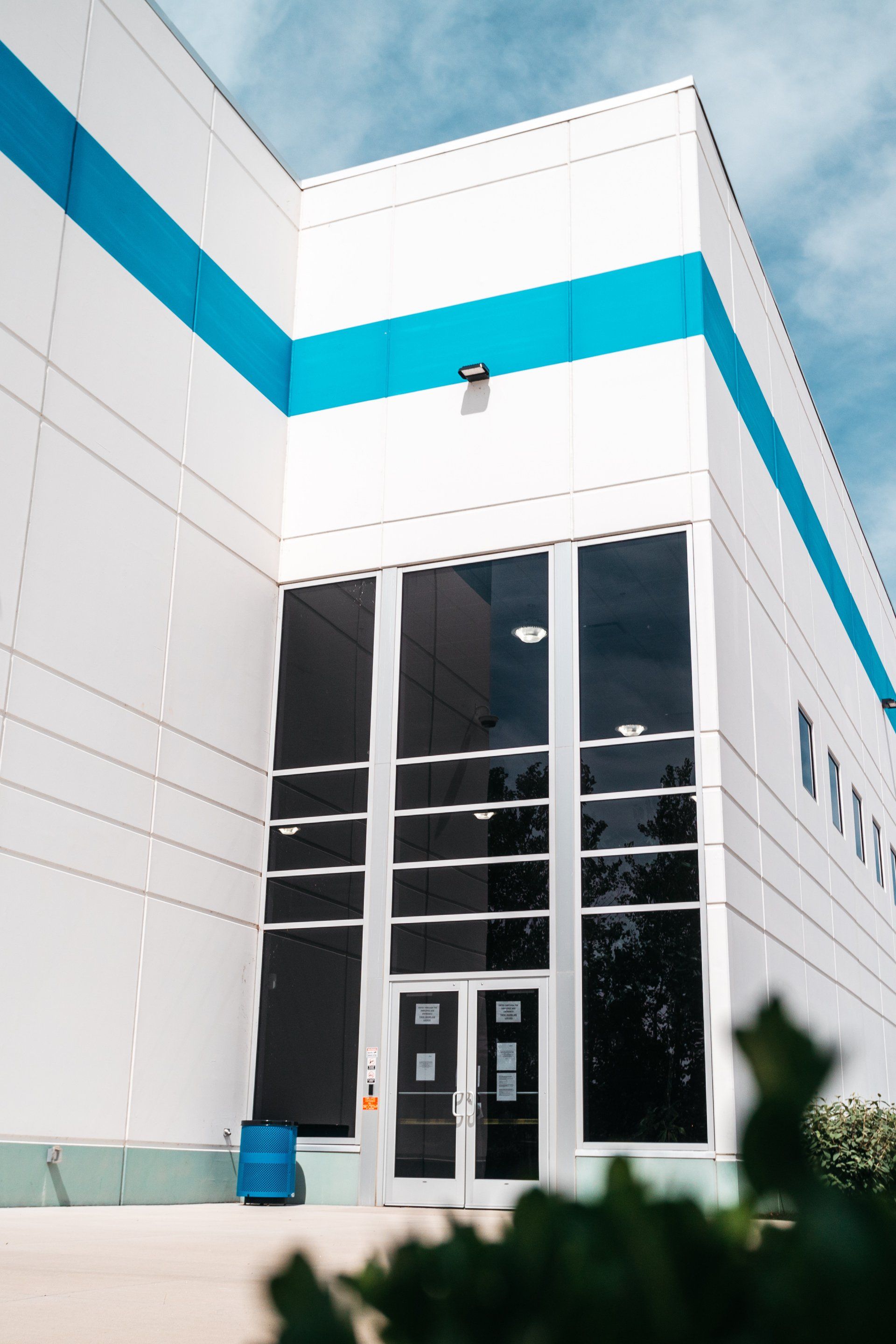 A Building With Blue And White Stripes Design — Willoughby, OH — Euclid Glass & Door