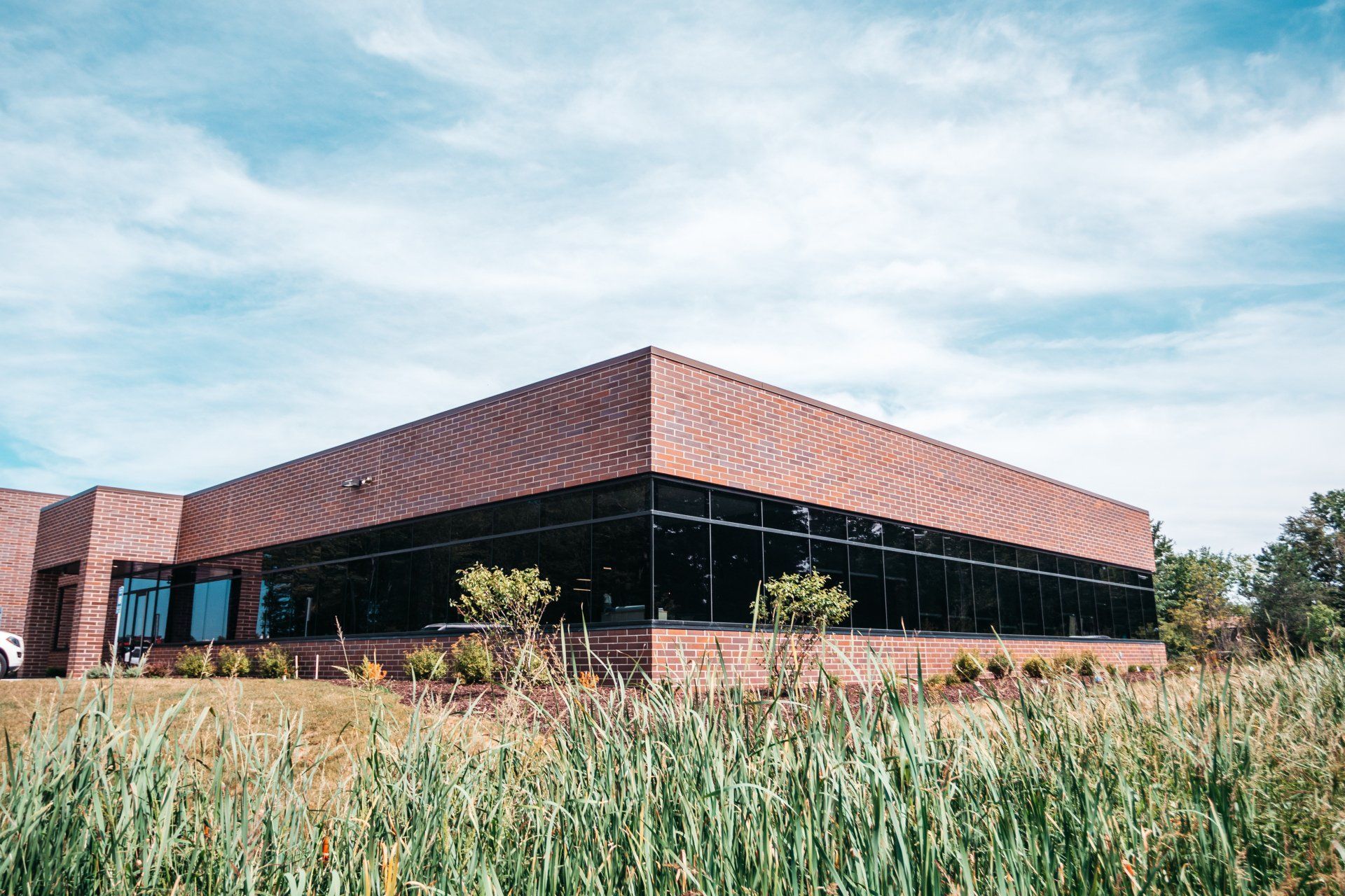 Far View of A Brick Building With Dark Tinted Glass Windows — Willoughby, OH — Euclid Glass & Door
