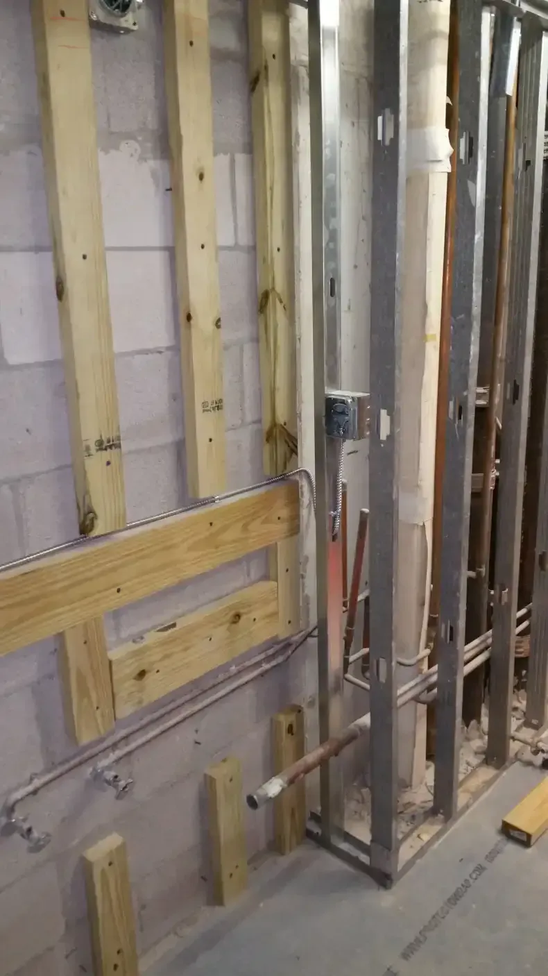 A building under construction with wooden beams and metal frames.