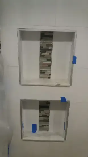 A couple of square boxes sitting on top of each other on a wall.