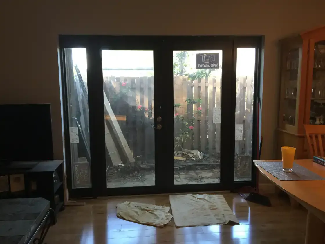 A living room with sliding glass doors leading to a backyard