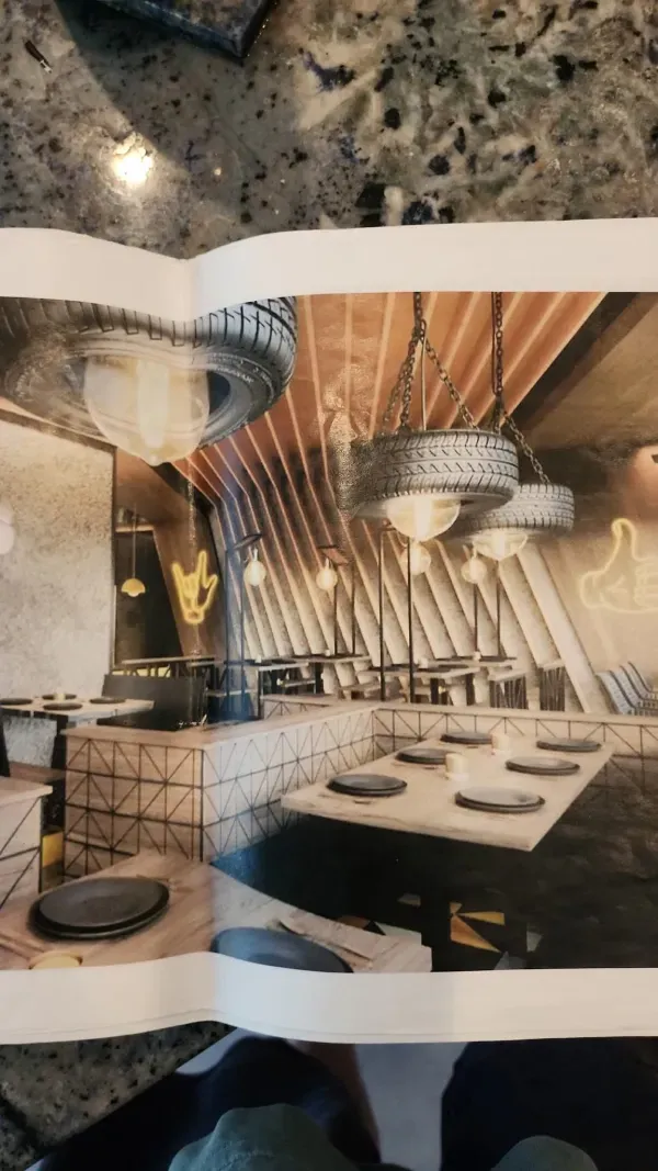 A picture of a restaurant with tables and chairs on a table.