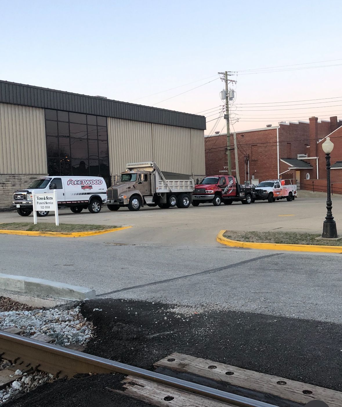 A Row Of Trucks Are Parked In Front Of A Building | Southern, IN | OK&A Fleetwood Asphalt Concrete Raising