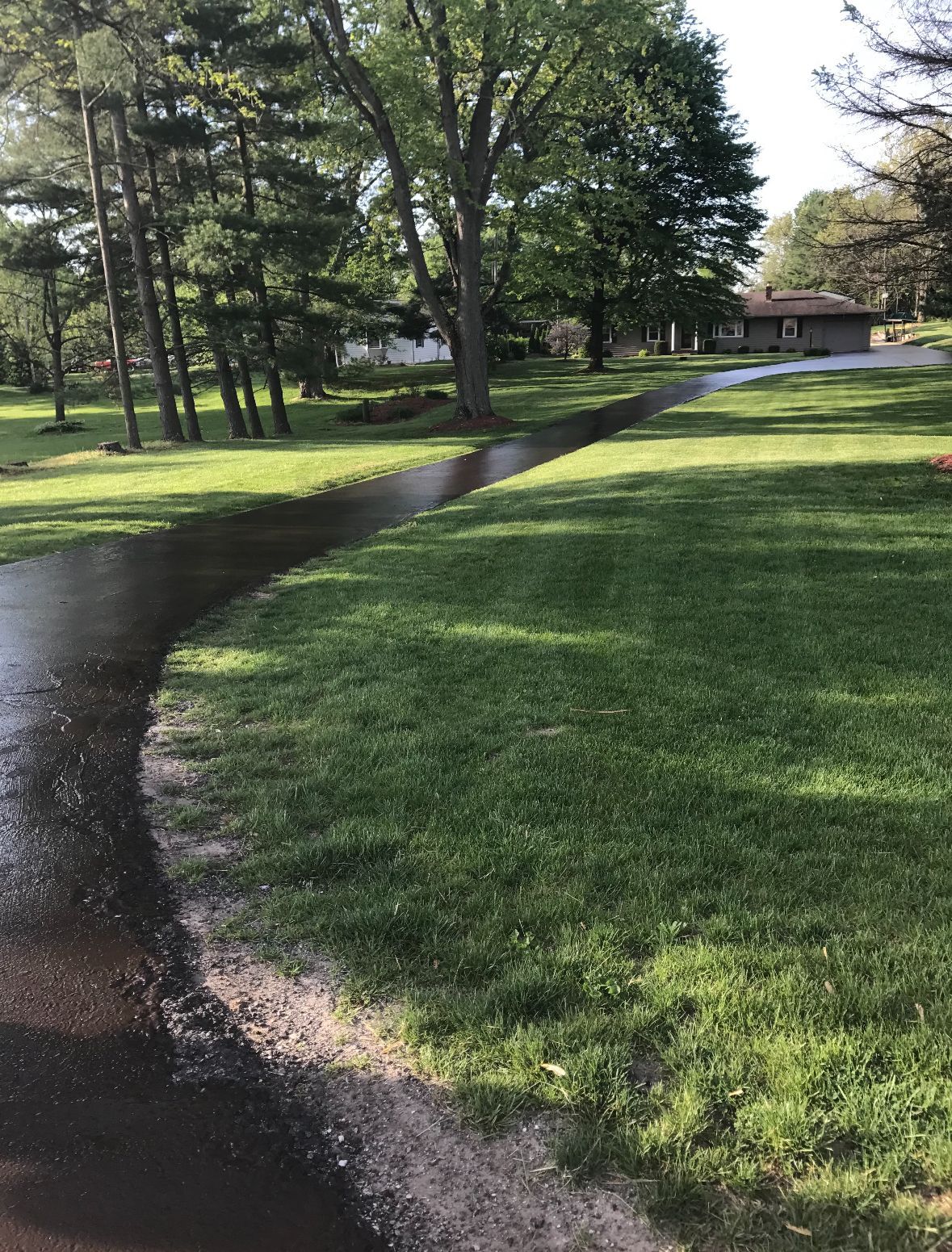 A Driveway Going Through A Lush Green Field | Southern, IN | OK&A Fleetwood Asphalt Concrete Raising