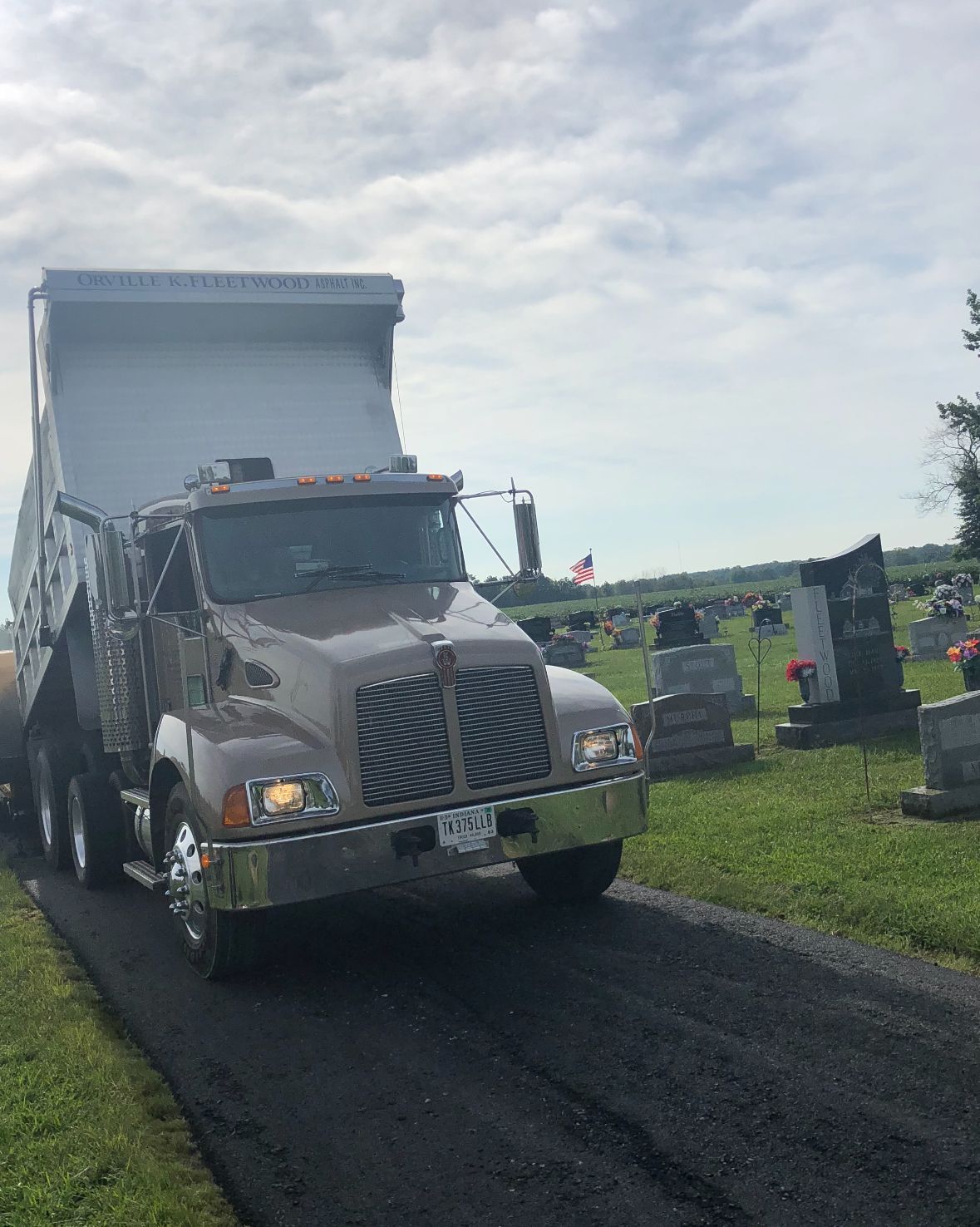 A Dump Truck Is Driving Down A Gravel Road | Southern, IN | OK&A Fleetwood Asphalt Concrete Raising
