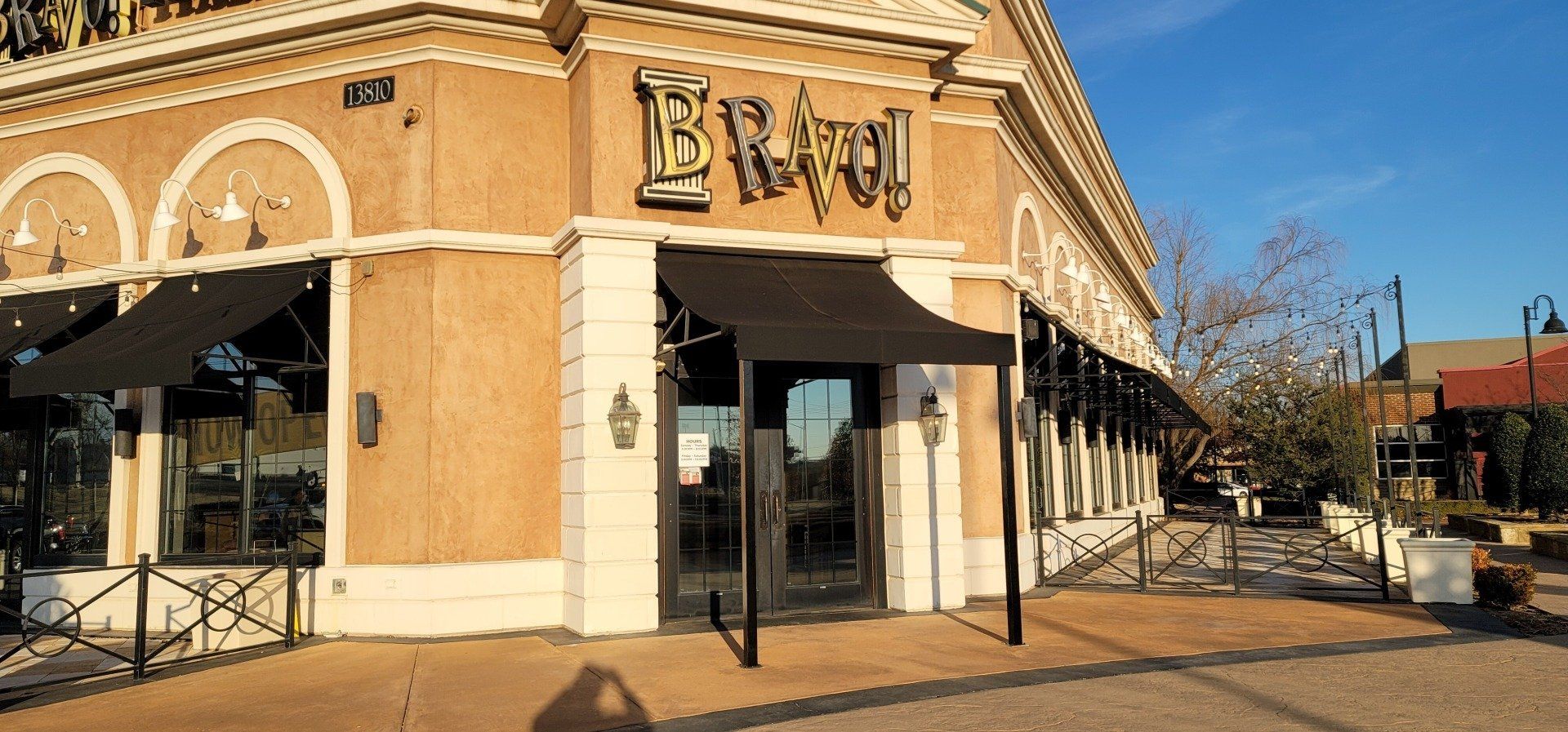 A large building with a lot of windows and awnings on the side of it.