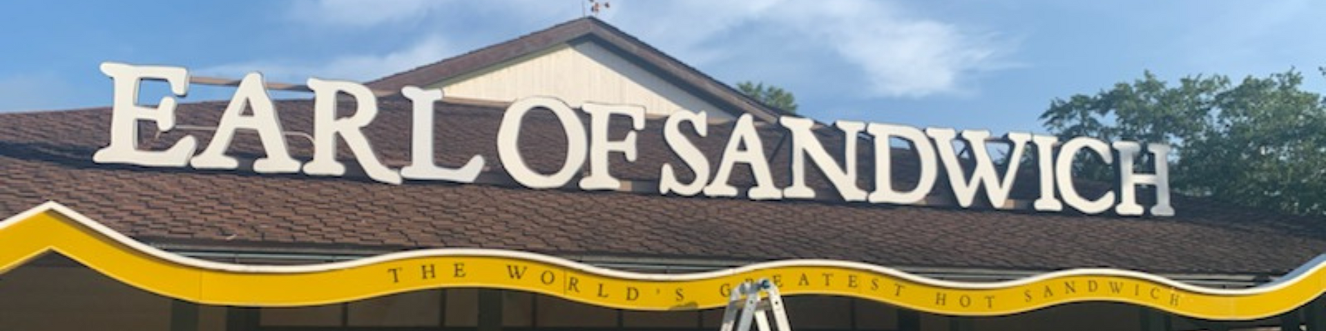 a sign for earl of sandwich is above a building