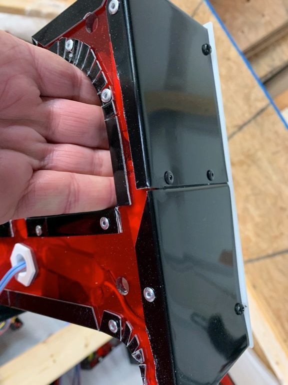 A close up of a person 's hand on a red and black object