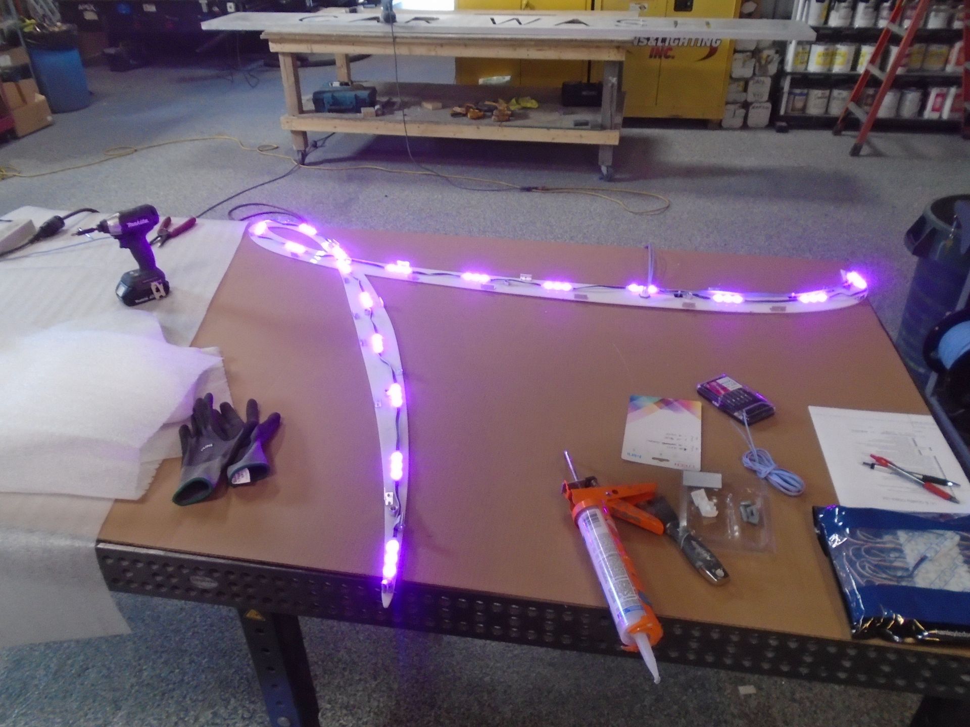 A table with purple lights and tools on it