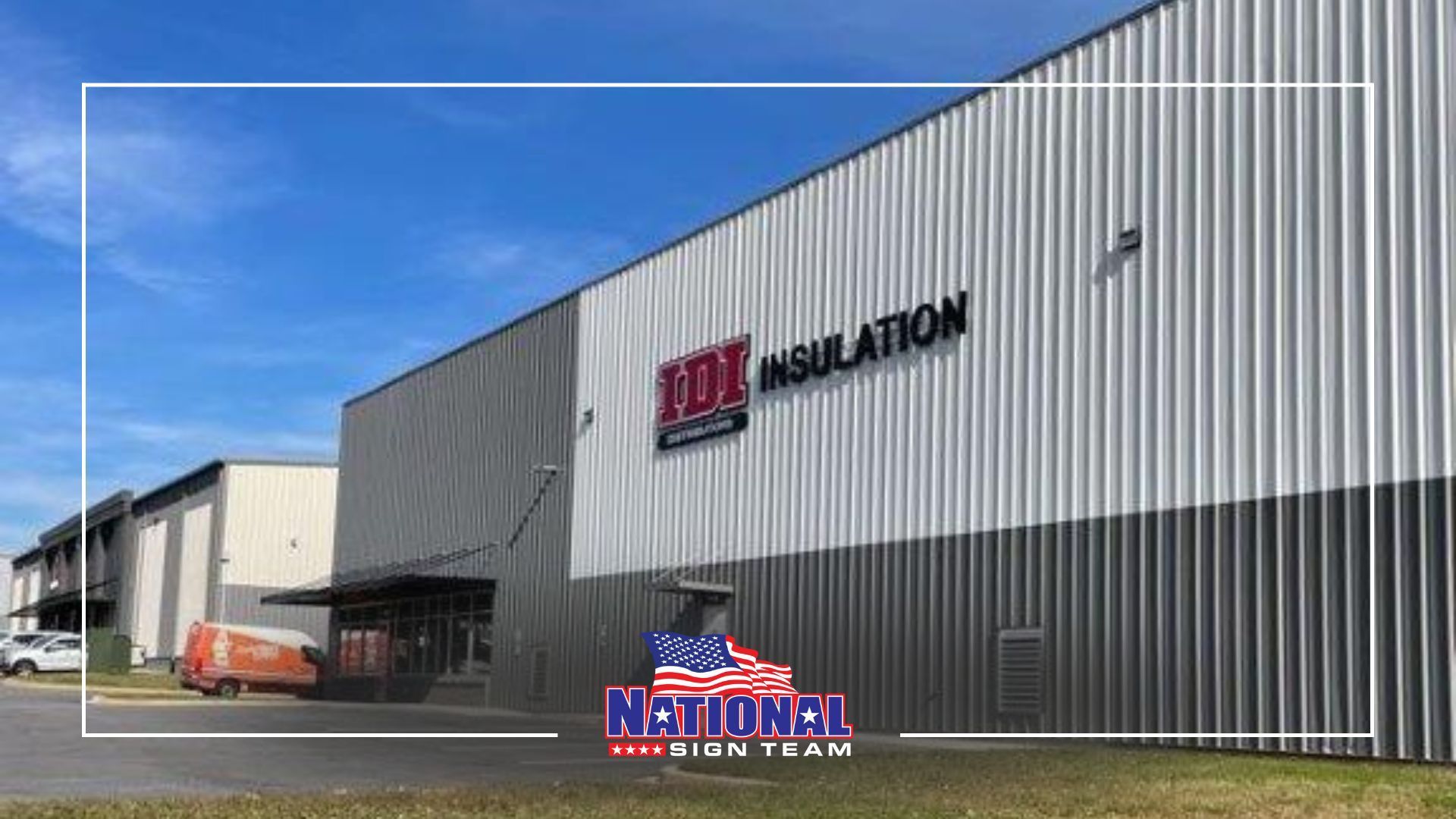 Exterior of a gray and white industrial building with 