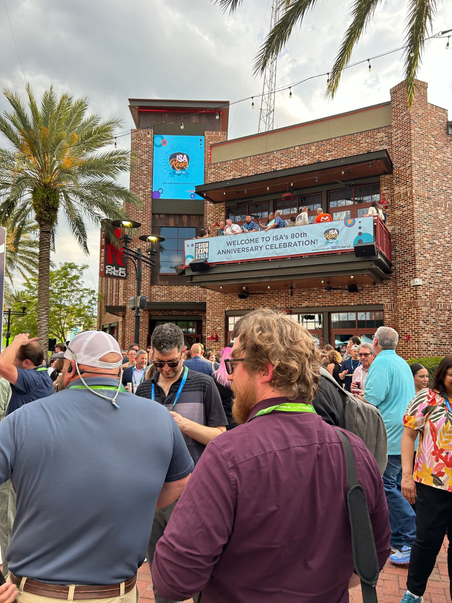 A group of people are standing in front of a building.
