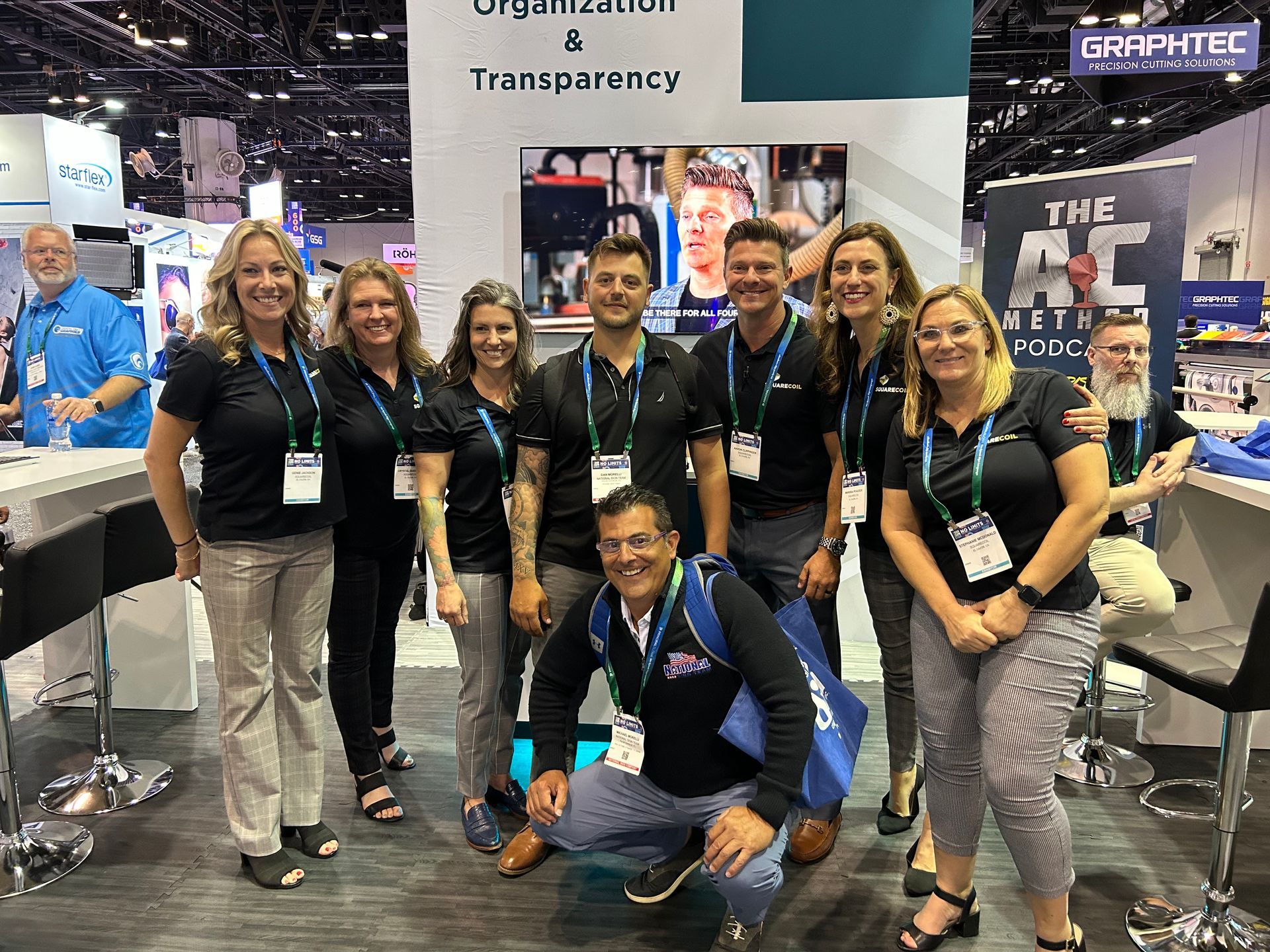 A group of people are posing for a picture at a convention.