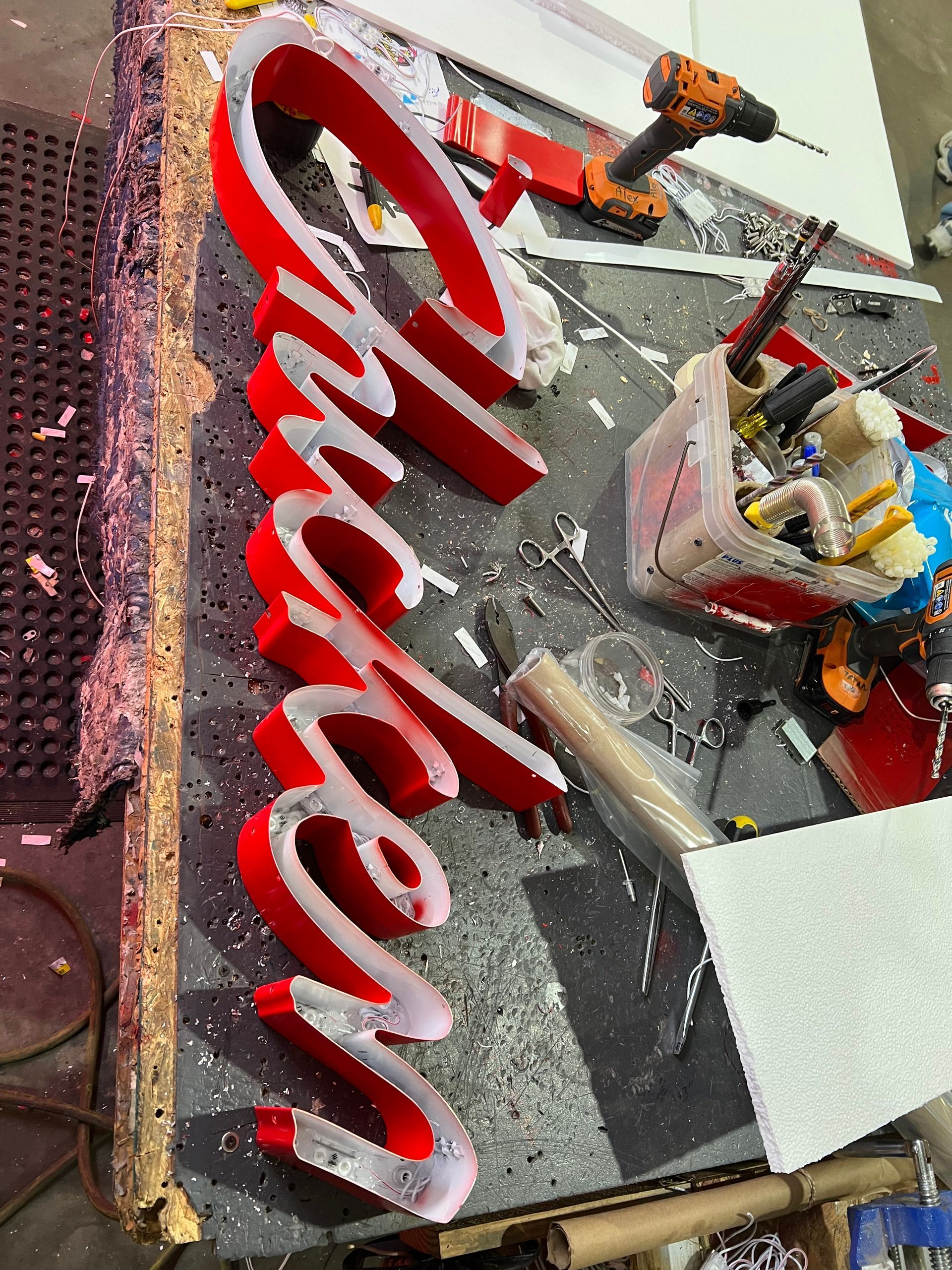 A red sign that says chicken is being built on a table.