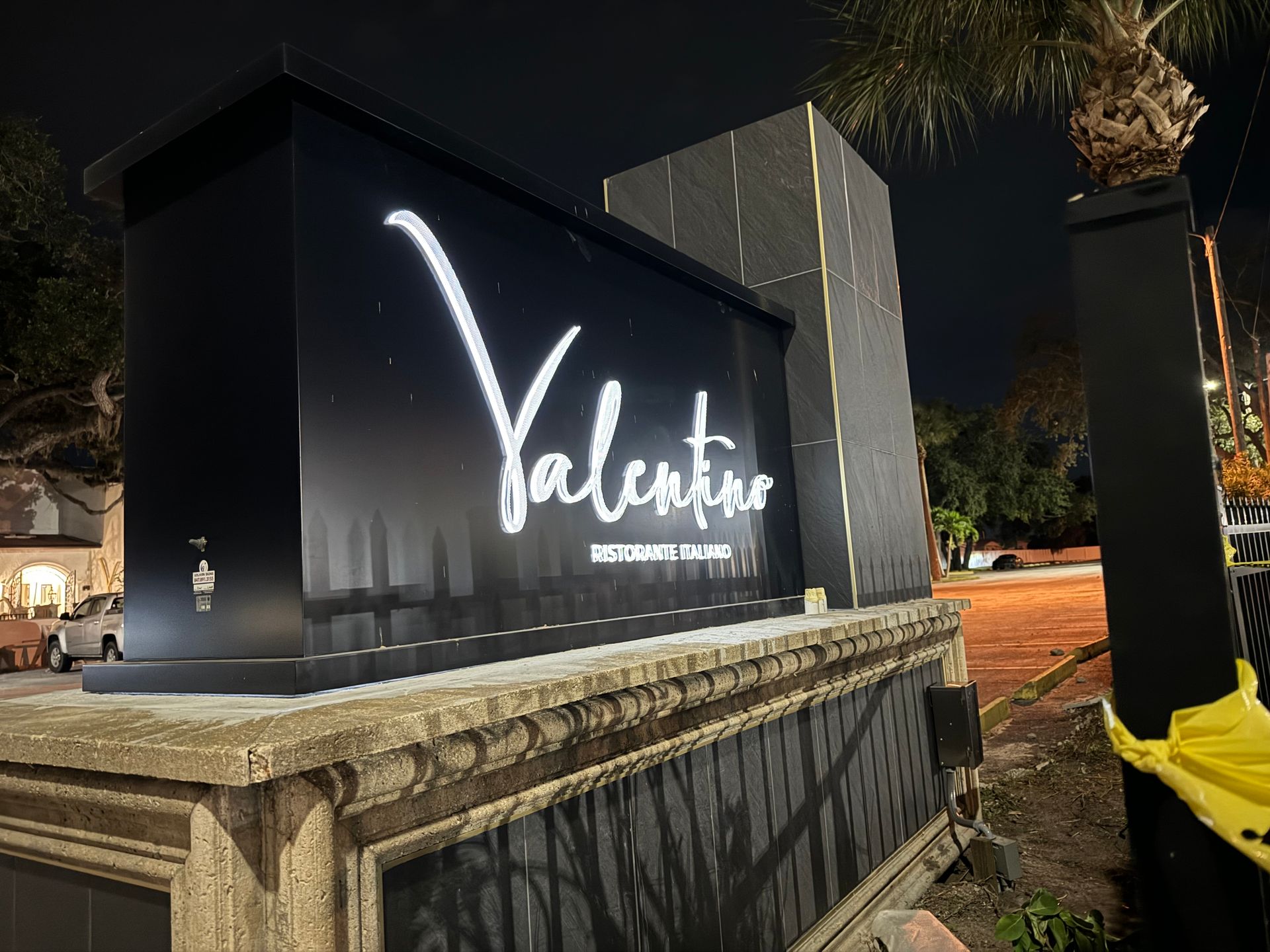 A valentine sign is lit up at night