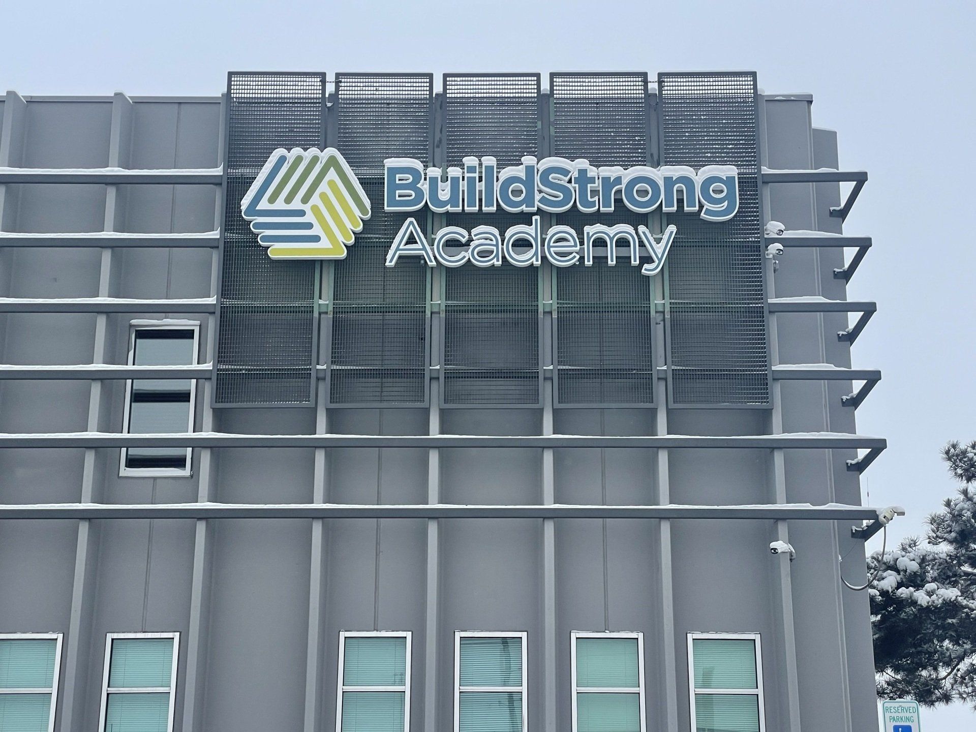 A building with a sign that says buildstrong academy