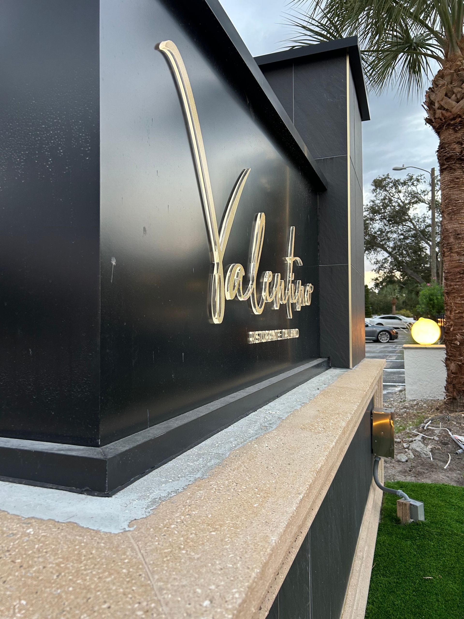 A black sign with the word valentine written on it