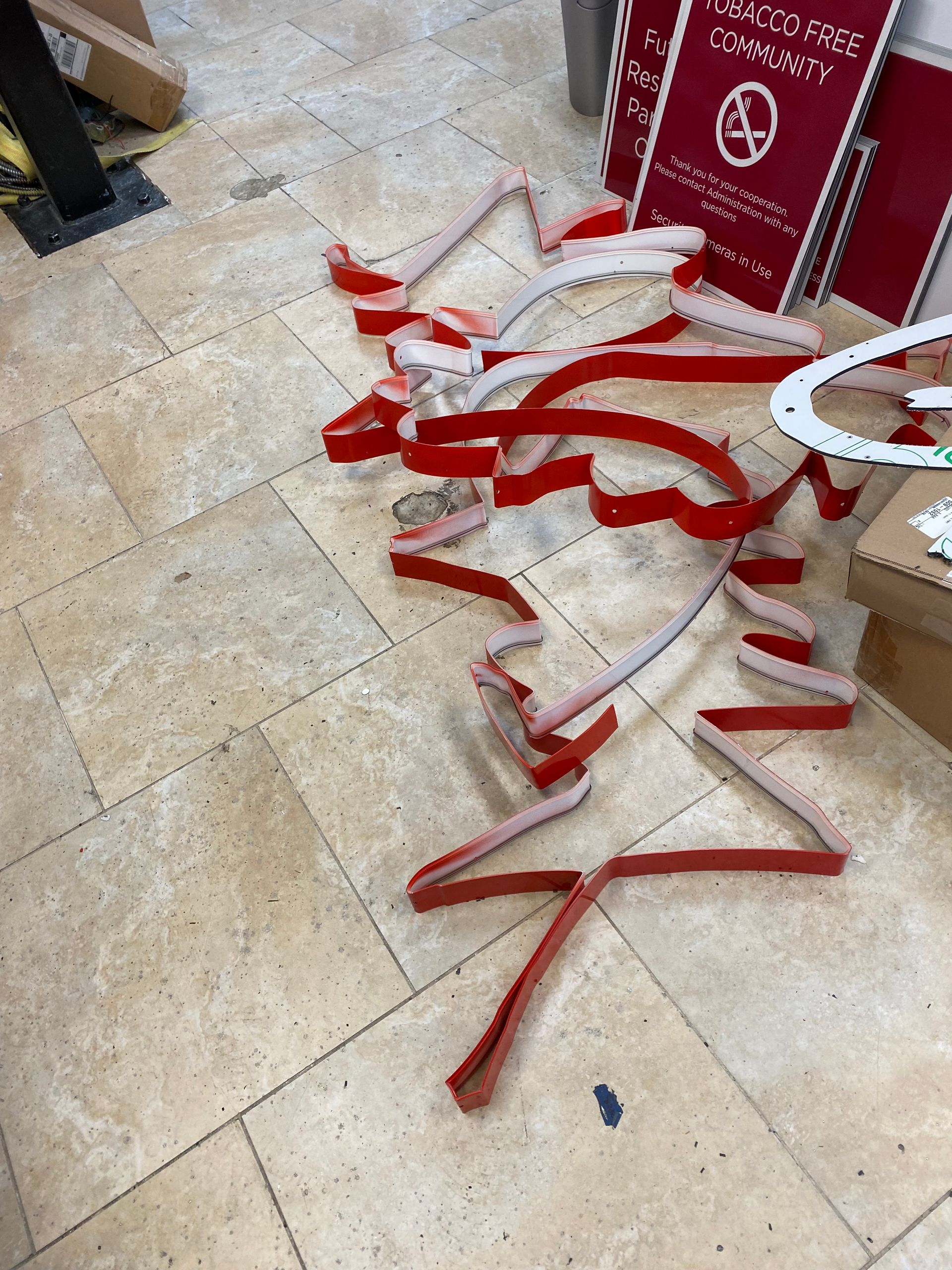 A bunch of red ribbons are laying on the floor