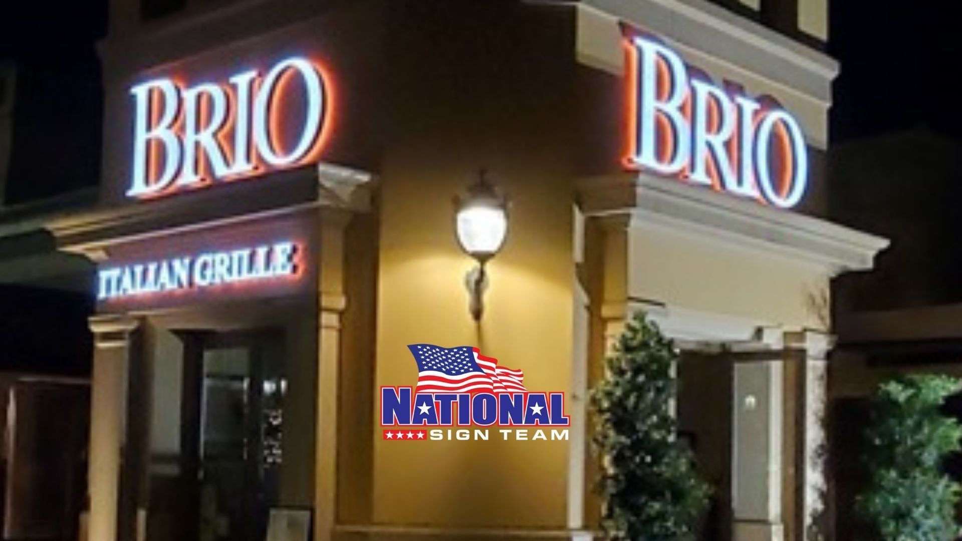 Brio Italian Grille illuminated sign at night, featuring a red and blue lit logo.