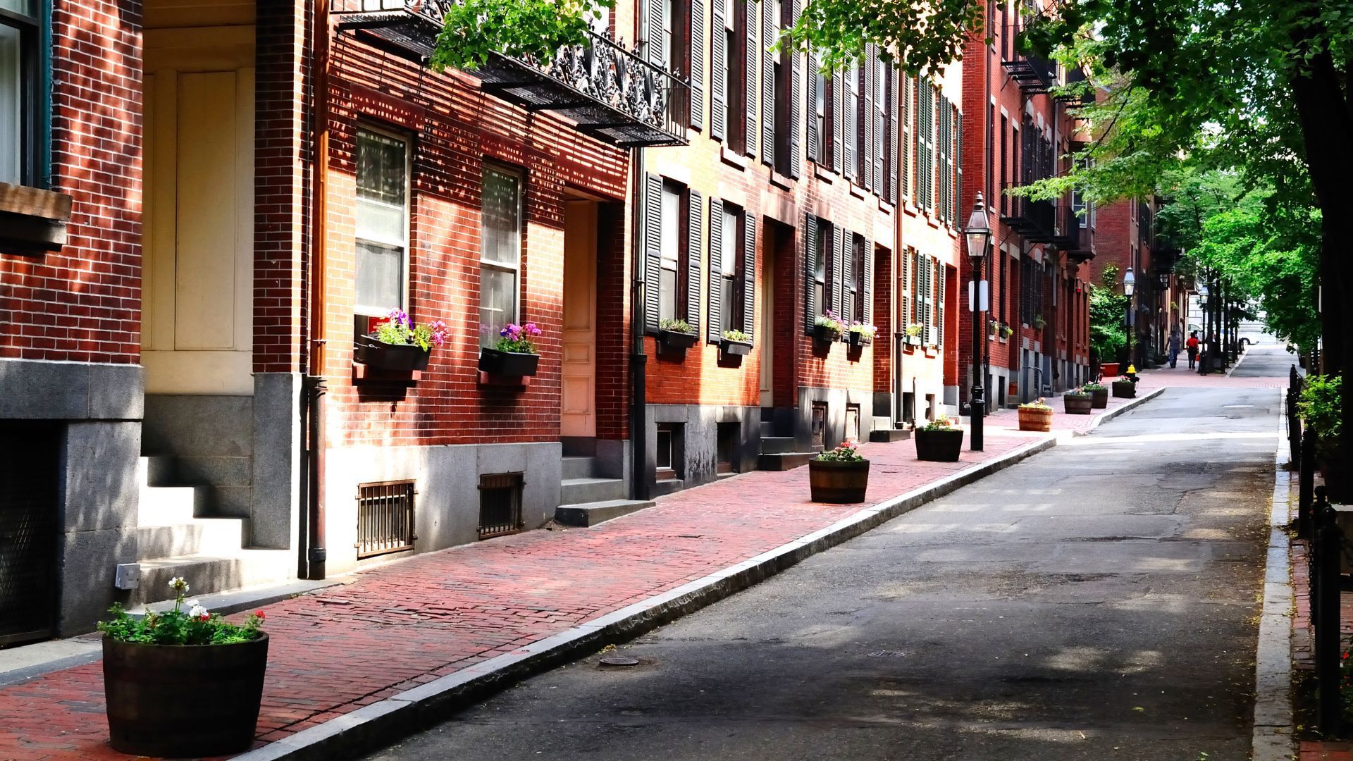 A row of brick houses on a narrow street