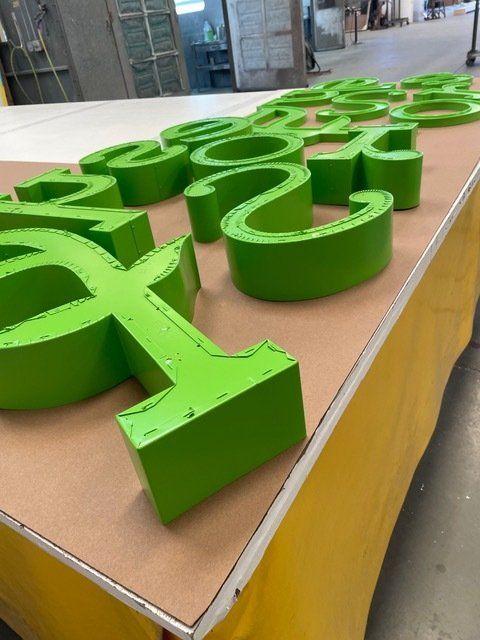 Green letters on a table with a yellow table cloth