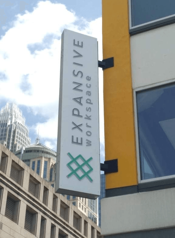 A sign on the side of a building that says expansive workspace