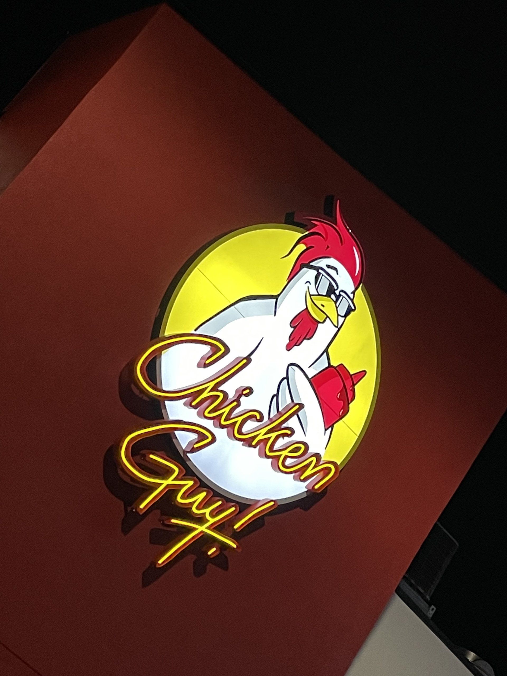 A sign for chicken guy with a chicken on it