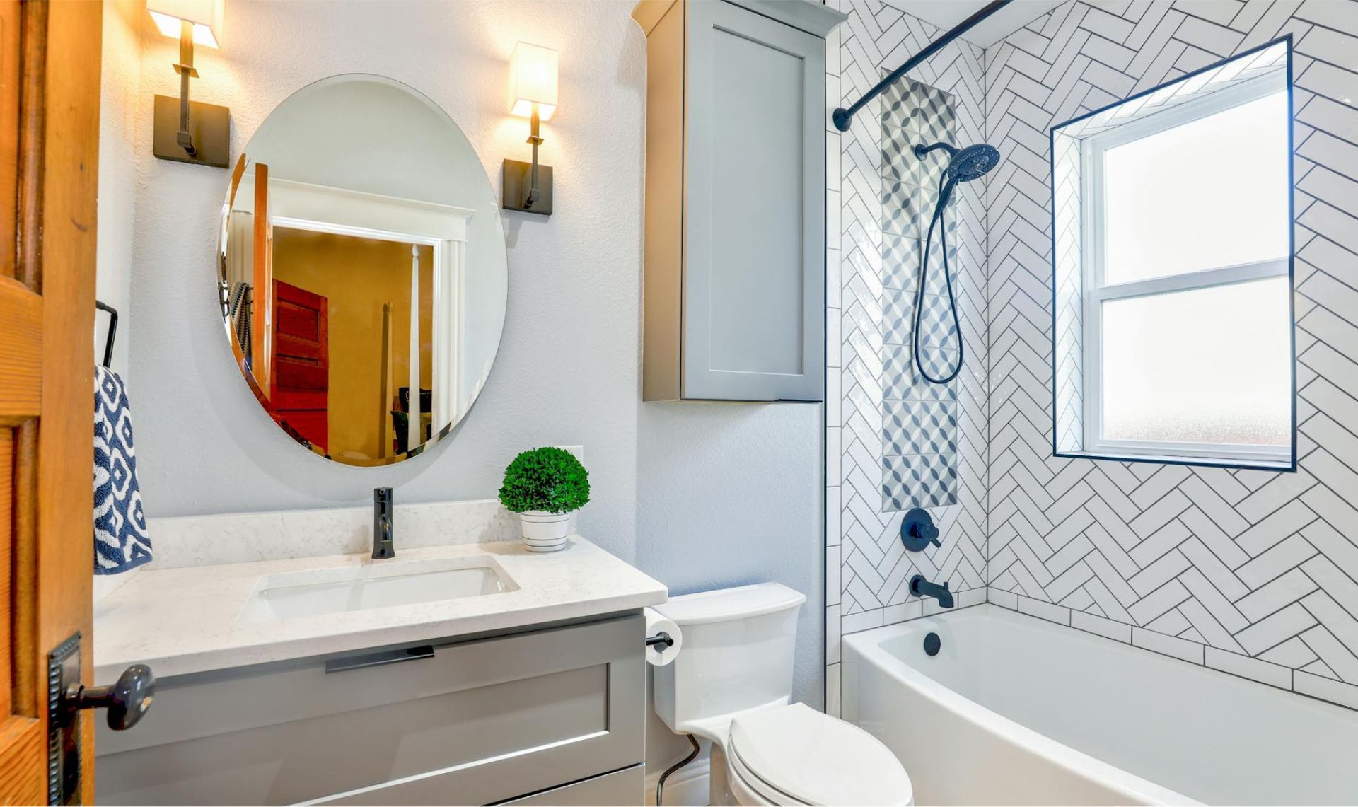 A bathroom with a toilet , sink , and bathtub.
