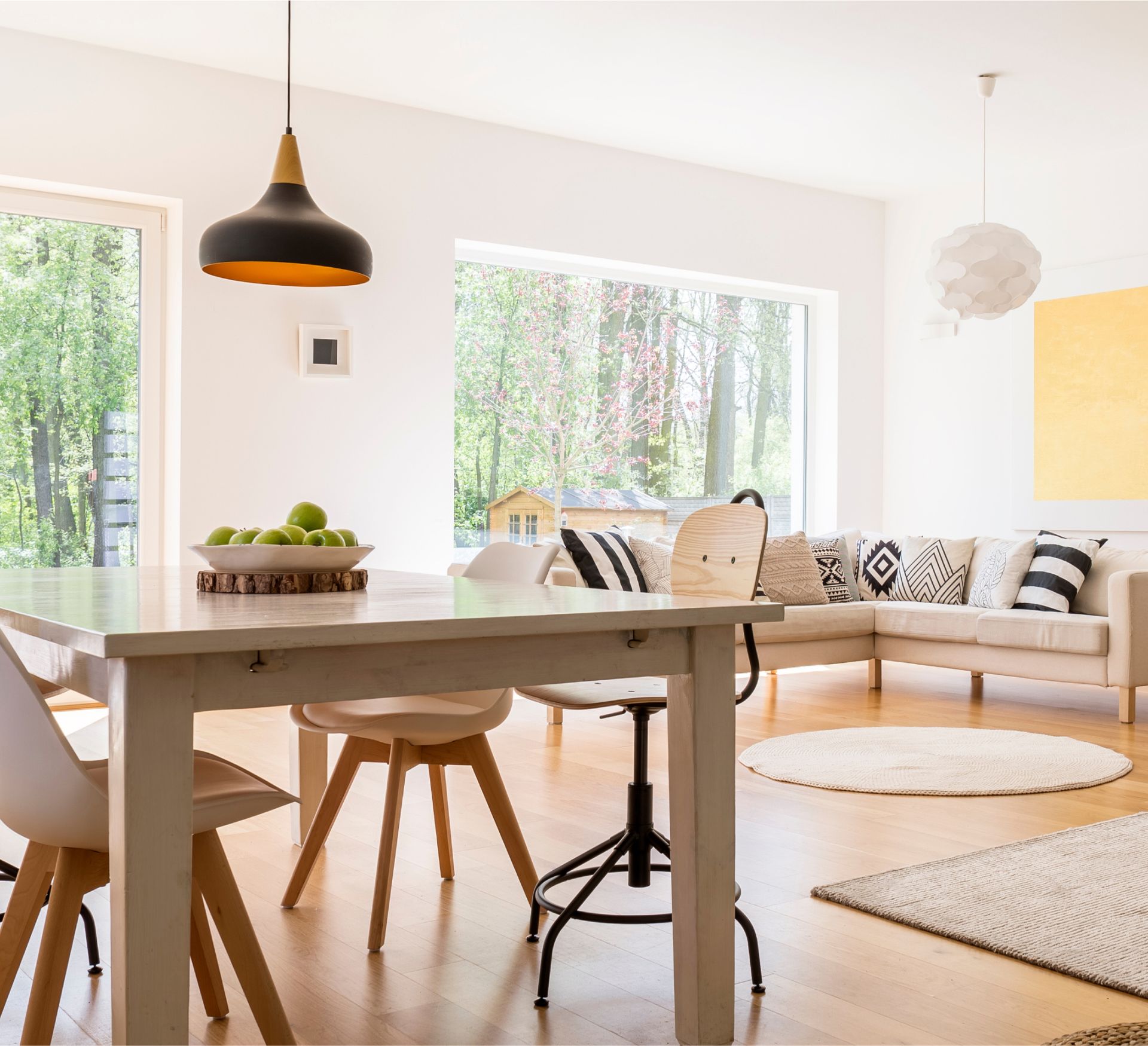 A living room with a table and chairs and a couch.