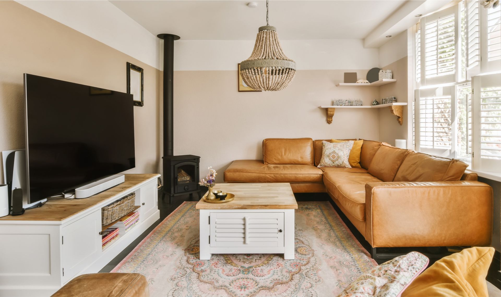 A living room with a couch , coffee table , television and fireplace.
