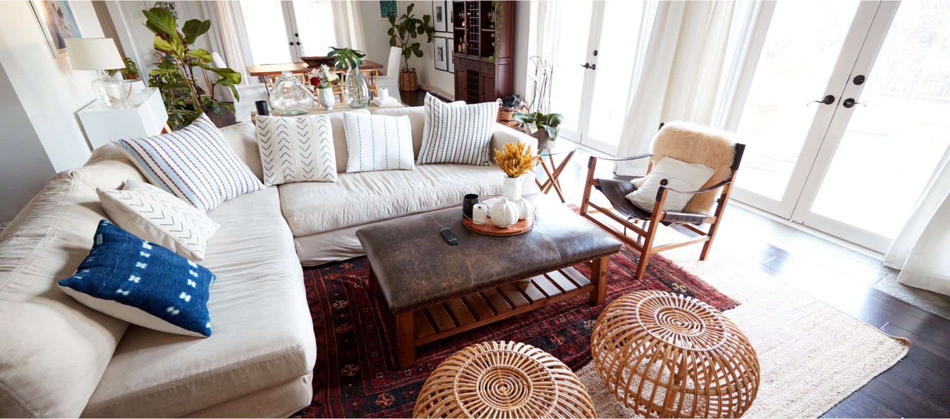A living room with a couch , chair , coffee table , and rug.