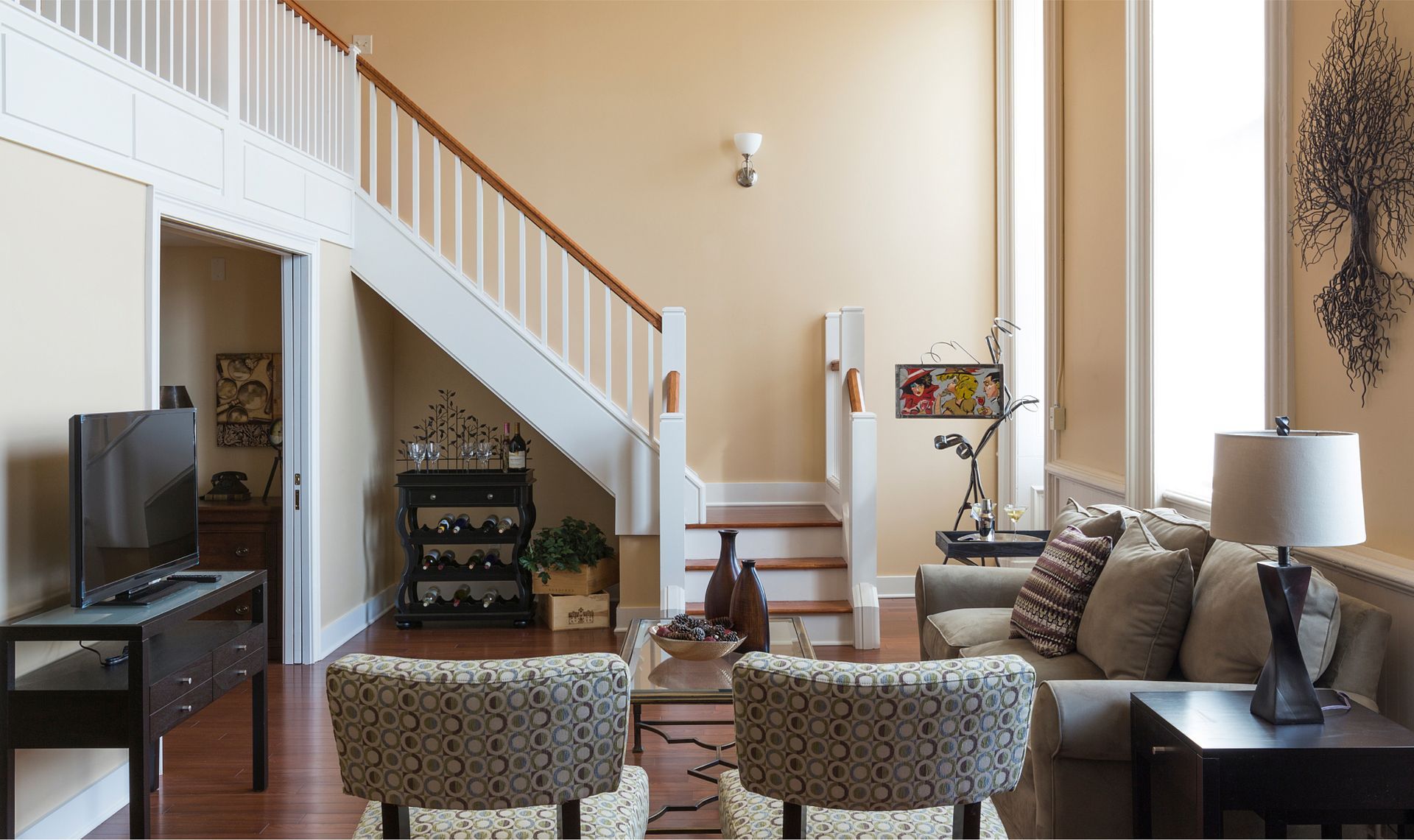 A living room with a staircase leading up to the second floor